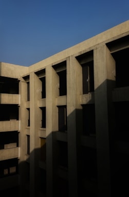 Photo of a sturdy concrete building facade under clear sky.