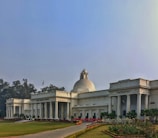 The Supreme Court of India building exterior under a clear blue sky