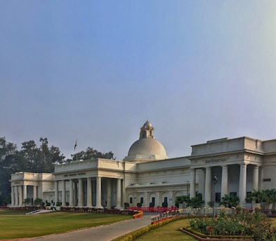 A dignified Indian institutional building with the civic logo prominently displayed, bathed in warm natural light.