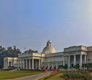 The Supreme Court of India building exterior under a clear blue sky