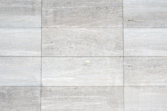 a close up of a white tiled wall