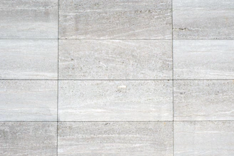 a close up of a white tiled wall