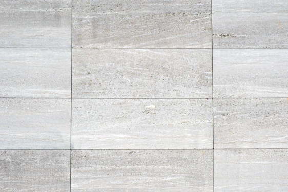 a close up of a white tiled wall