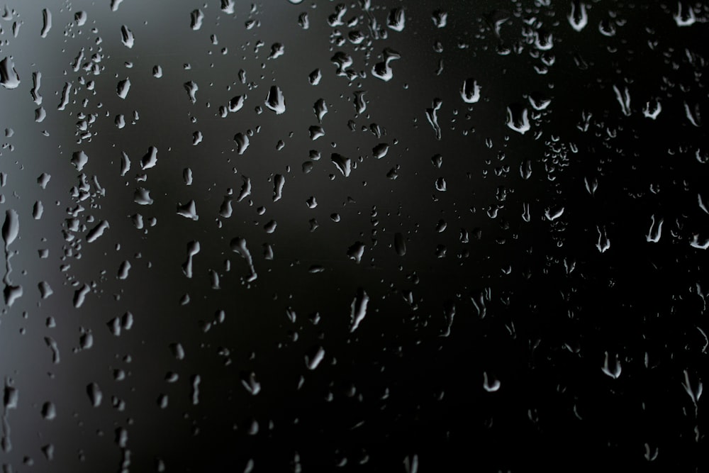 rain drops on a window with a black background