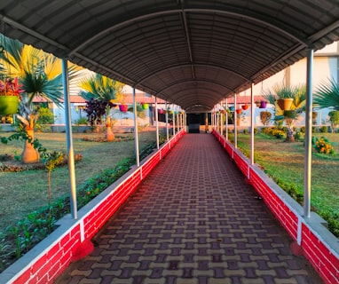 a walkway in a building with a red brick walkway