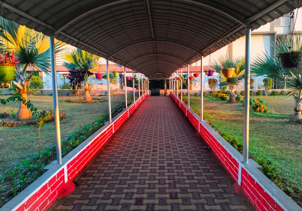 a walkway in a building with a red brick walkway