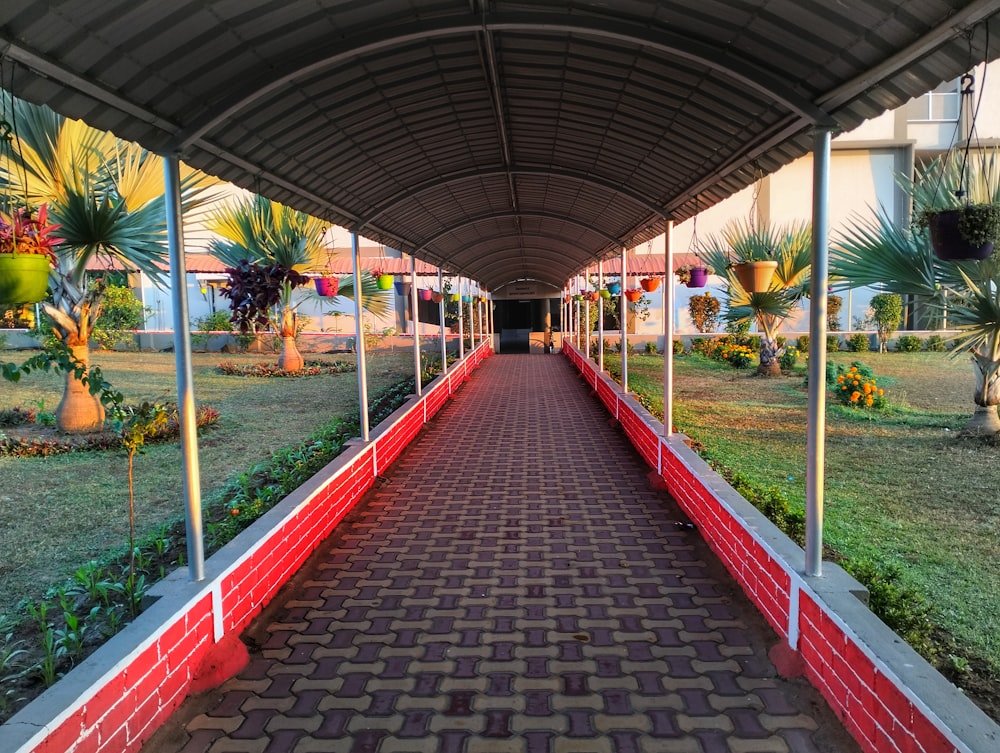 a walkway in a building with a red brick walkway