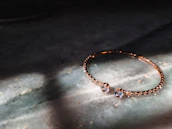 Luxurious bracelet sparkling on a velvet cushion with soft golden light.