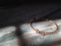 Elegant stainless steel bracelet resting on a soft velvet cloth with natural light highlighting its smooth finish.