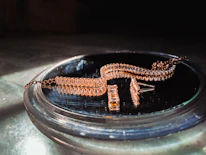 A stunning display of traditional gold jewelry with intricate designs under warm lighting.