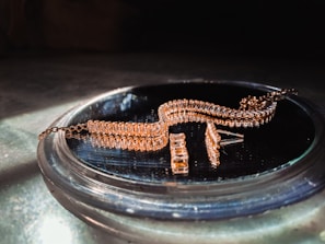 Close-up of an intricately designed gold necklace sparkling under soft lighting.
