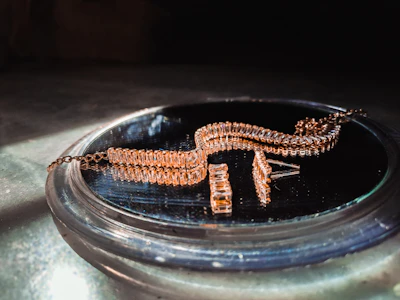 A stunning display of traditional gold jewelry with intricate designs under warm lighting.