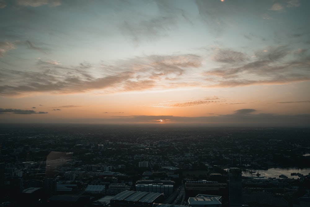 the sun is setting over a large city