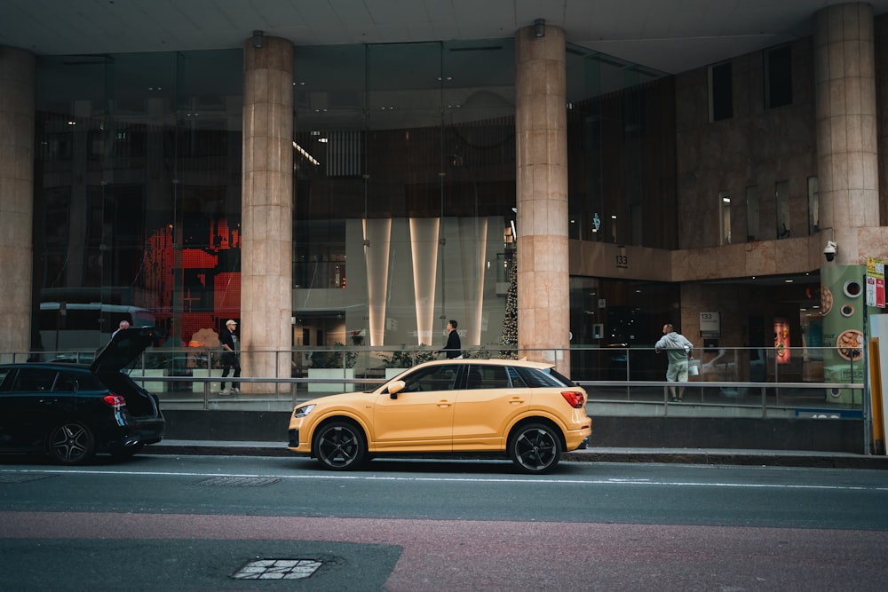 a yellow car is parked in front of a building