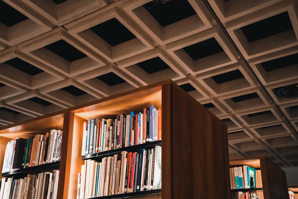 a bookshelf filled with lots of books in a library