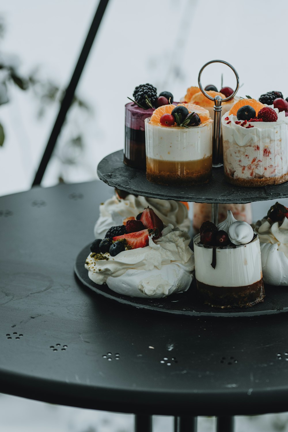 a black table topped with three tiered cakes