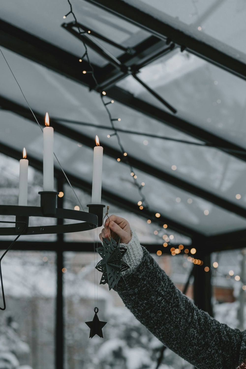 a woman holding a lit candle in her hand