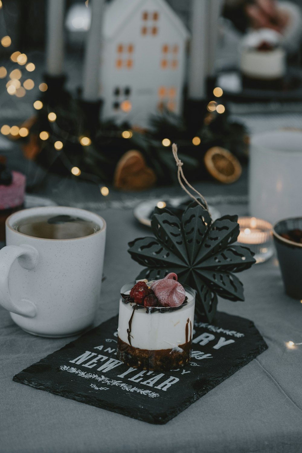 a table topped with a cake next to a cup of coffee