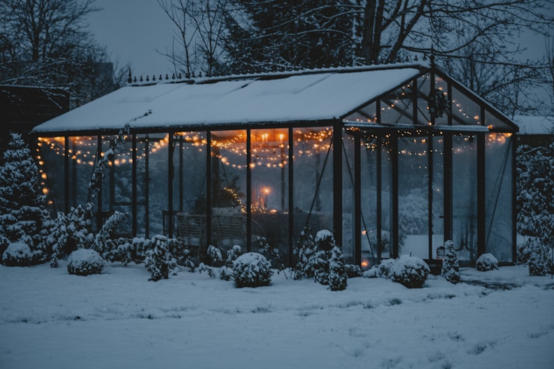 a house with a lot of lights on it in the snow