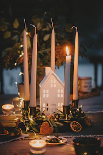 A cozy event setup featuring personalized candles as charming table centerpieces.
