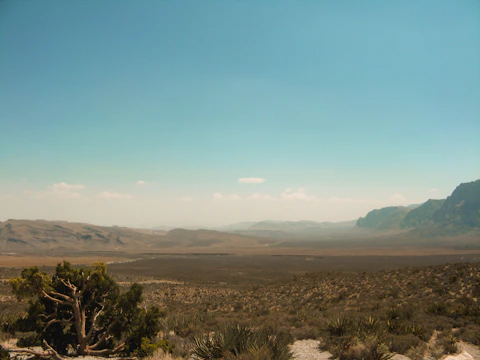 A distant desert landscape under a vast blue sky.