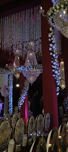 Ania J captivating an elite audience during a glamorous gala performance, surrounded by chandeliers and golden lighting.