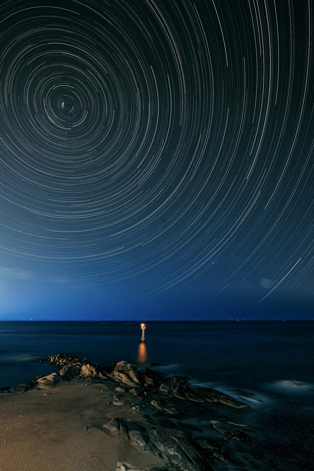 a star trail over a body of water