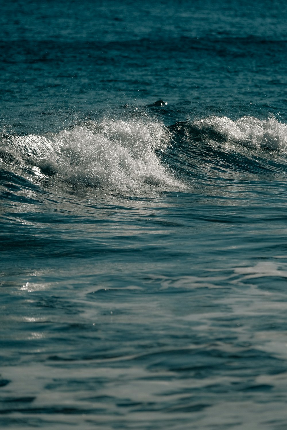 a man riding a wave on top of a surfboard