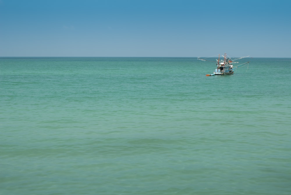 two people on a boat in the middle of the ocean