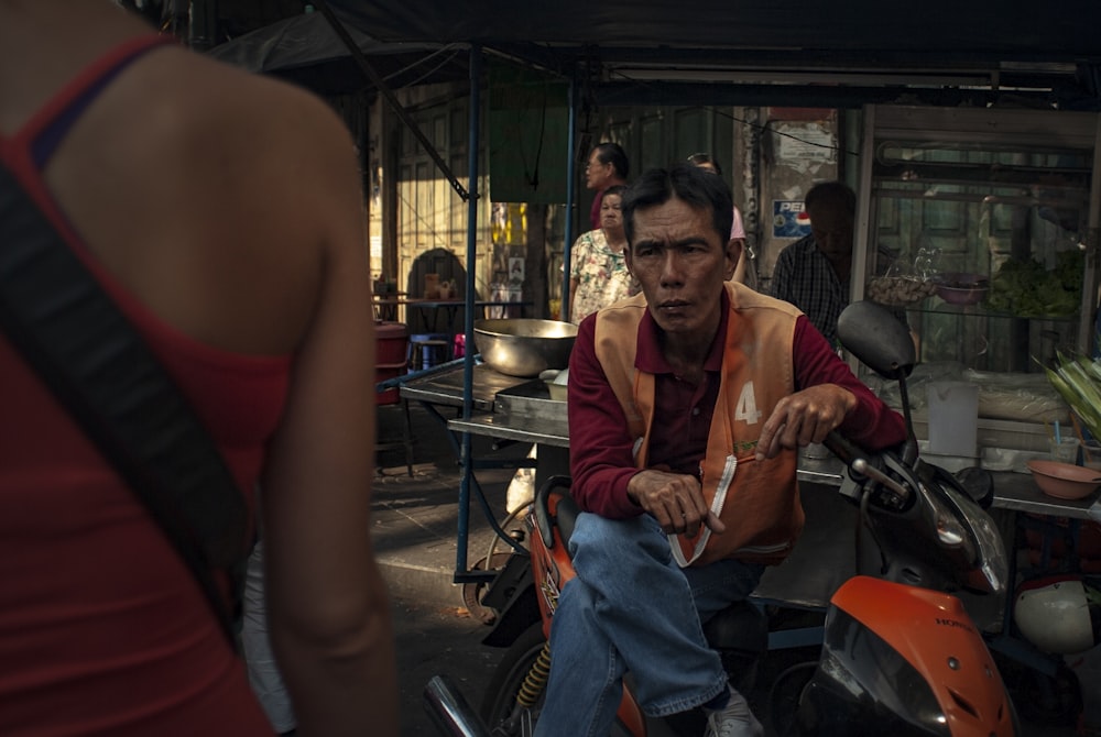 a man sitting on a motorcycle in the street