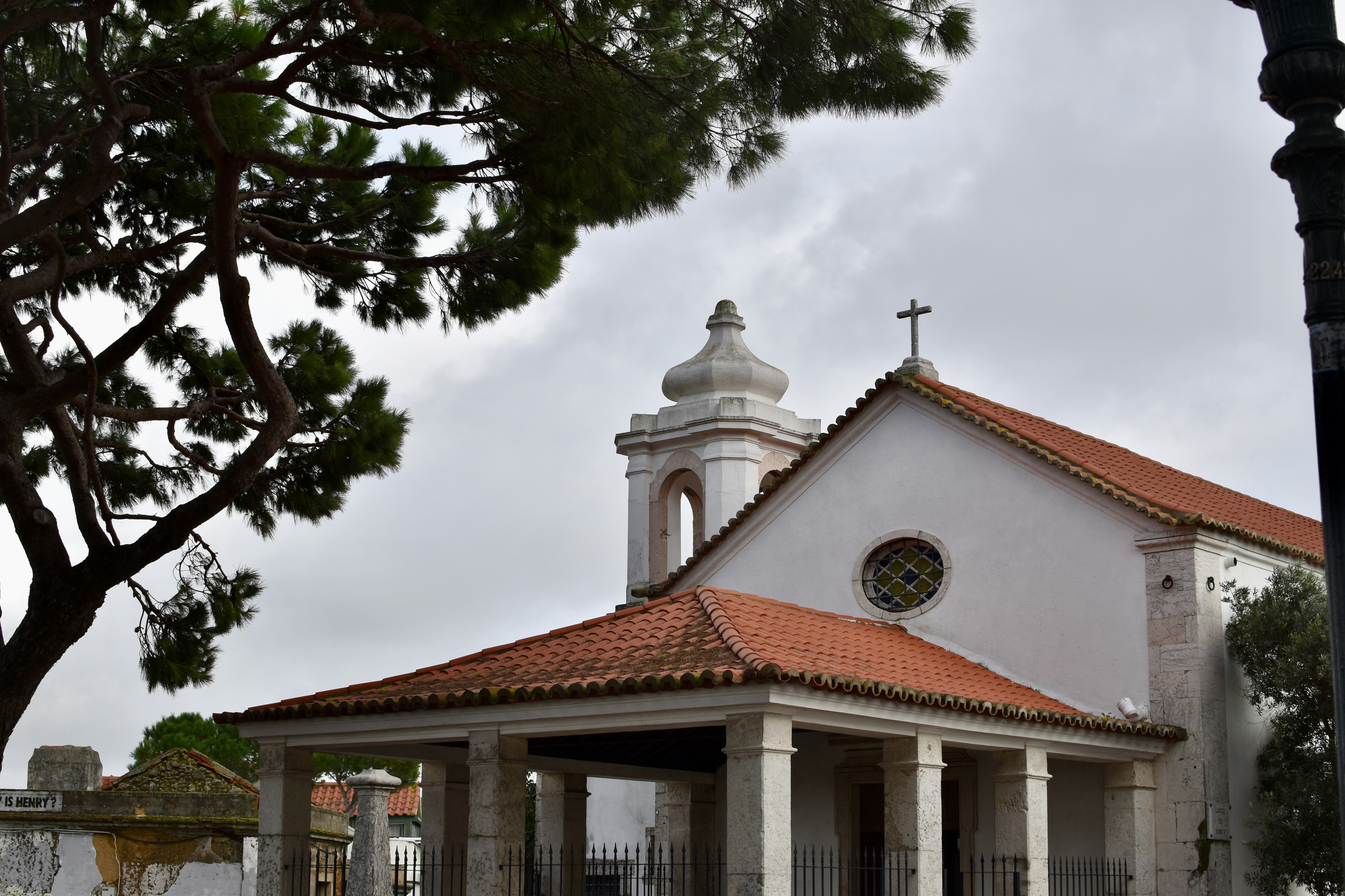 a white church with a red roof and a cross on top
