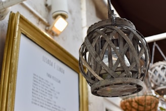 a picture frame hanging from the ceiling next to a light fixture