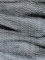 A close-up of soft, textured denim fabric in natural colors.