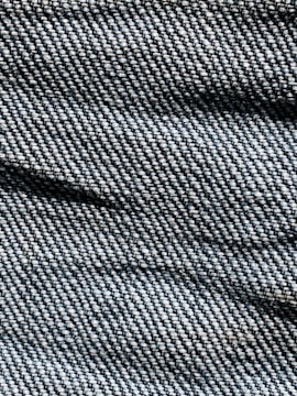 A close-up image of high-quality denim fabric with intricate textures.