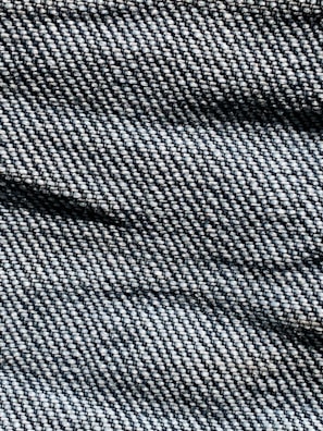 A close-up of soft, textured denim fabric in natural colors.