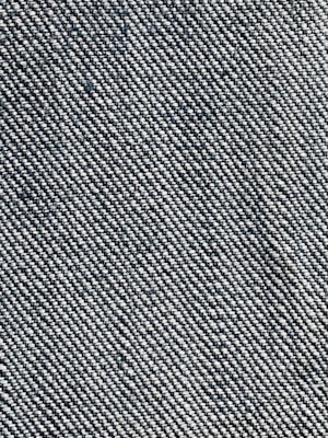 A close-up view of a woven fabric texture featuring a dense pattern of interlaced threads. The fabric appears sturdy and thick, with a prominent diagonal weave pattern, indicative of denim material.