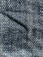 a close up of a blue and white tweed fabric