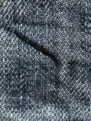 a close up of a blue and white tweed fabric