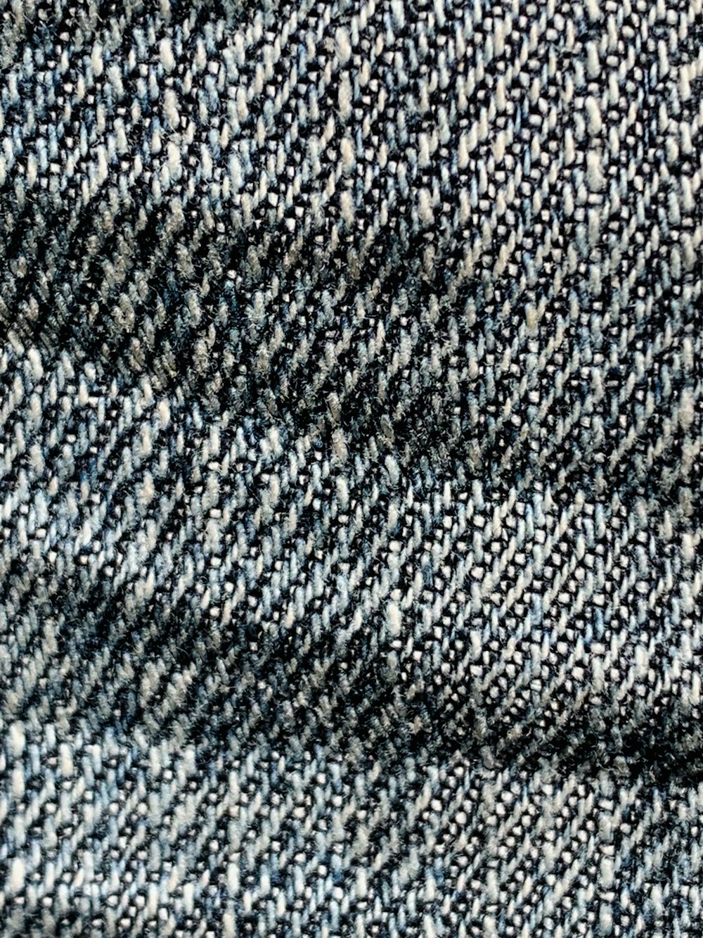 a close up of a blue and white tweed fabric