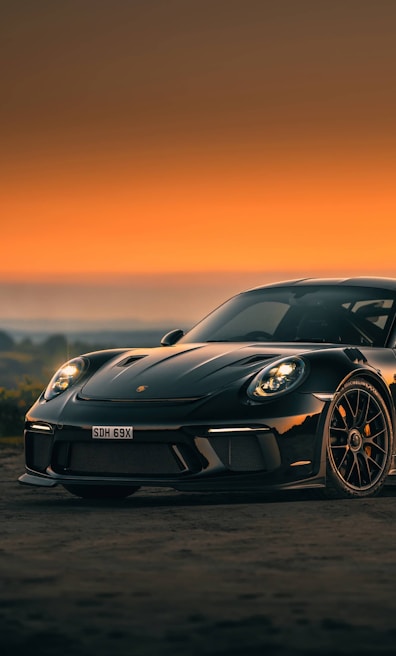A sleek black Lamborghini showcased against a sunset backdrop.