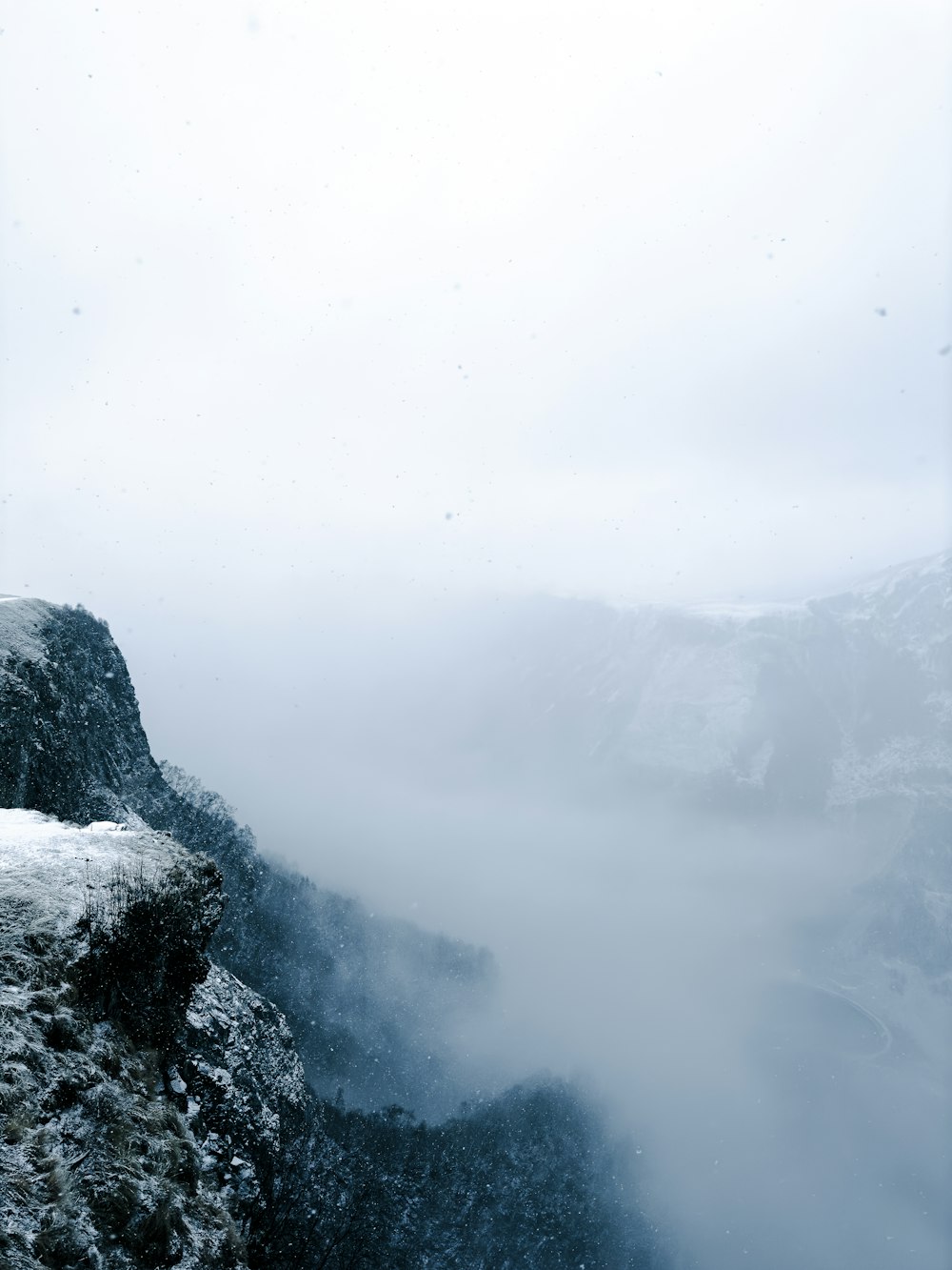 a person standing on top of a snow covered mountain