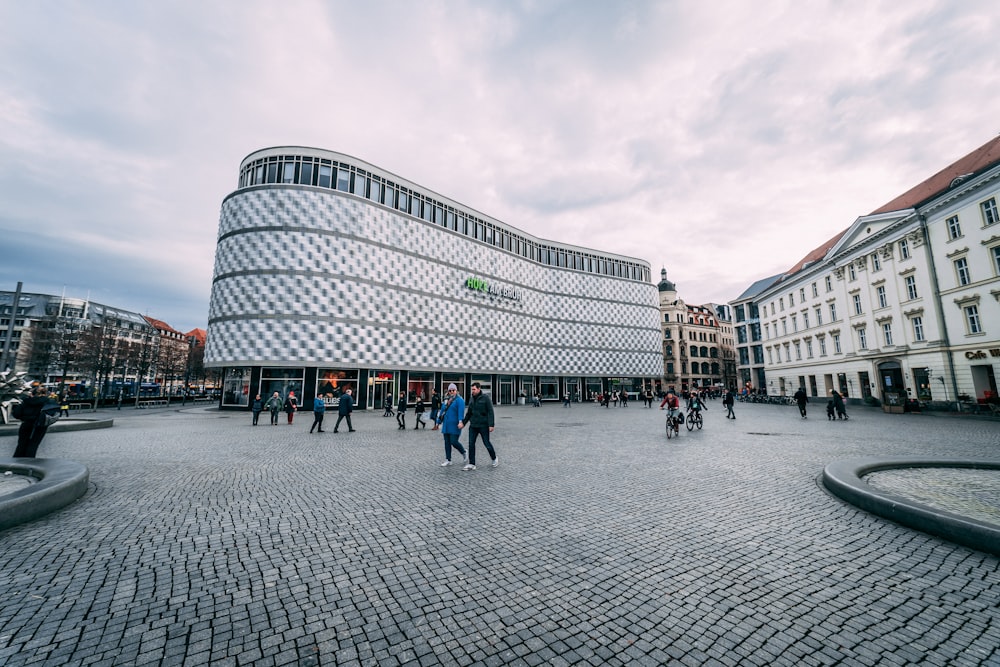 a group of people walking around a courtyard