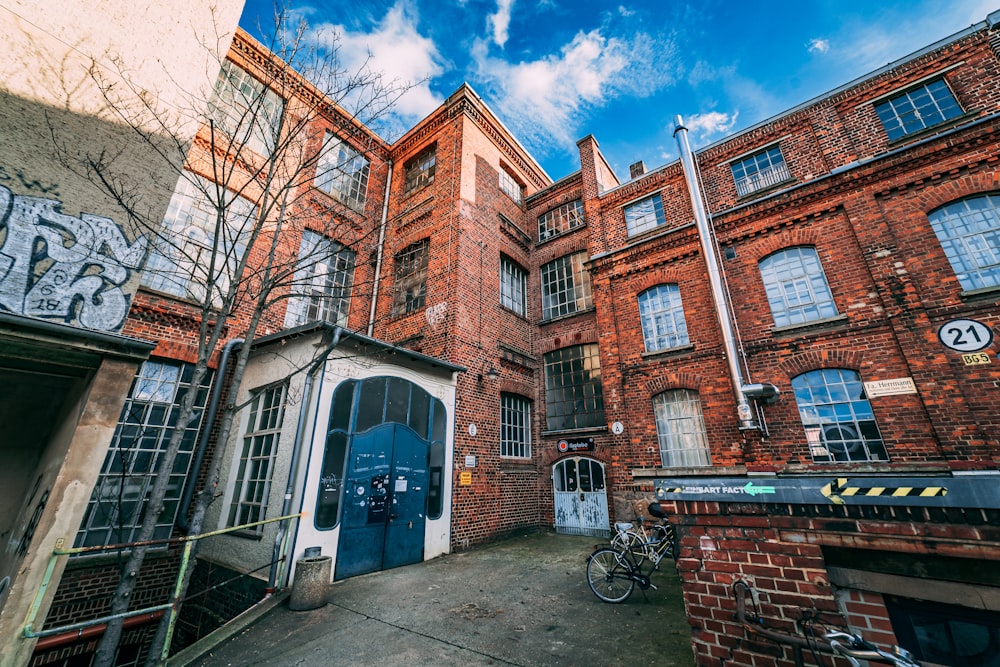 a brick building with a bicycle parked in front of it