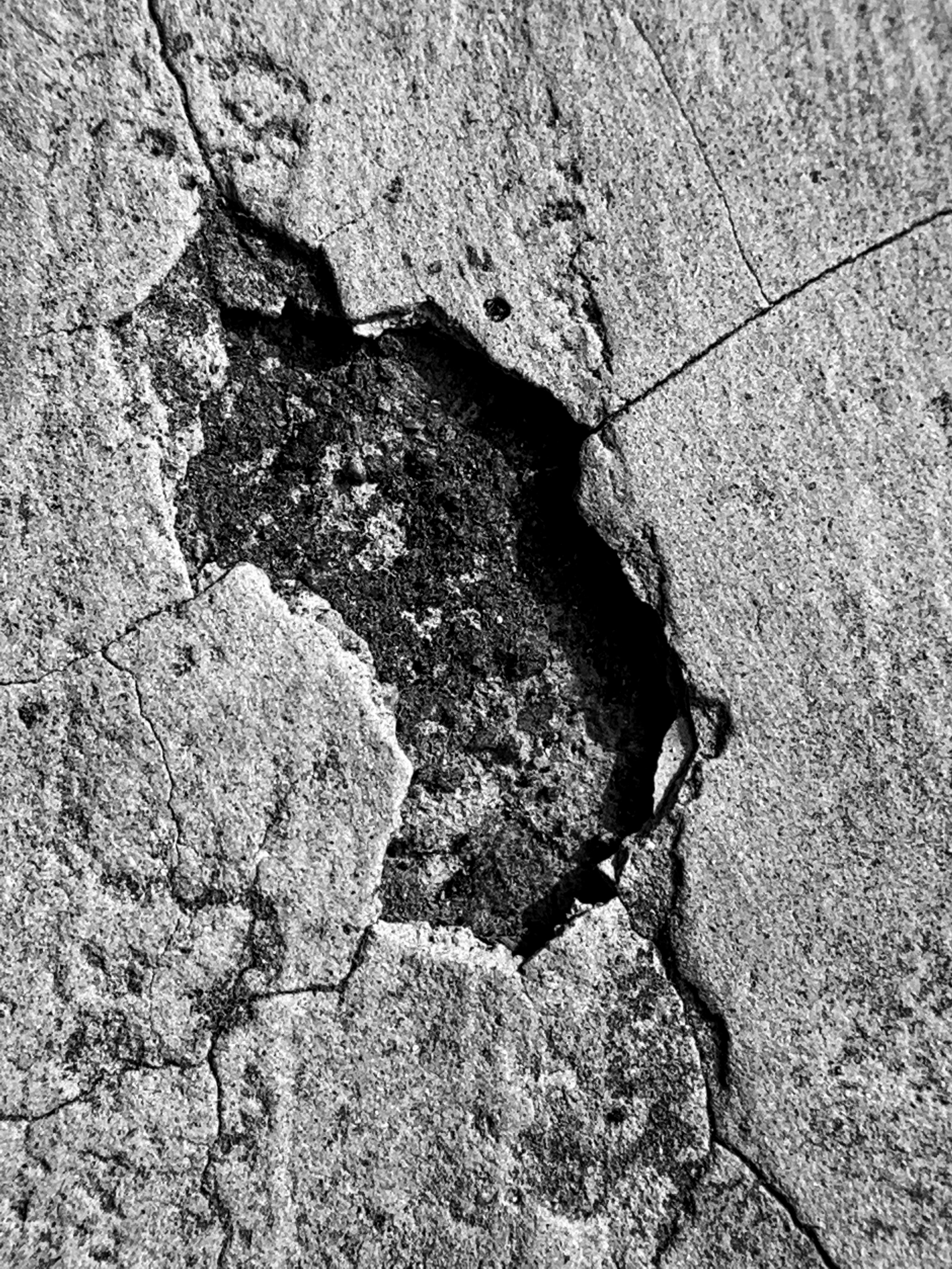 A black and white photo of a crack in a rock photo – Free Hole Image on ...