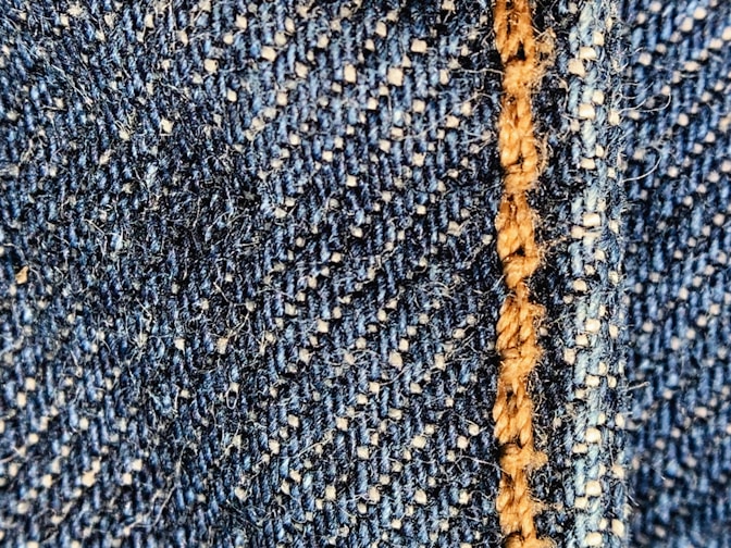 Close-up of a natural indigo-dyed artisanal fabric with delicate stitching.
