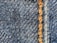 Close-up of a sturdy industrial uniform fabric with reinforced stitching.