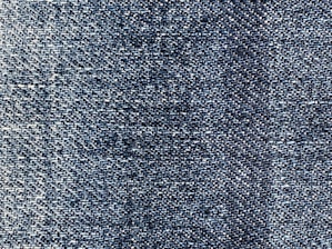 A close-up of high-stretch denim fabric showcasing its flexibility.