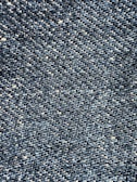 Close-up view of a textured denim fabric, showcasing a weave of blue and white threads.