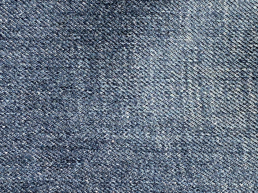 Close-up of deep indigo jeans fabric texture highlighting quality weave and dye consistency.
