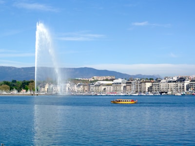 a large fountain spewing water into the air over a body of water